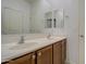 Bathroom featuring double sinks with neutral-toned cabinets and a large mirror at 23649 W Watkins St, Buckeye, AZ 85326