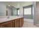 Bathroom featuring double sinks, large mirror, soaking tub, and a separate shower at 23649 W Watkins St, Buckeye, AZ 85326