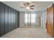 Bright, spacious bedroom with gray accent wall, ceiling fan, and carpet flooring at 23649 W Watkins St, Buckeye, AZ 85326