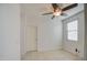 Well-lit bedroom featuring tile floors and a ceiling fan for added comfort at 23649 W Watkins St, Buckeye, AZ 85326