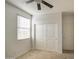 Bedroom with a ceiling fan, window, carpet, and closet with sliding doors at 23649 W Watkins St, Buckeye, AZ 85326