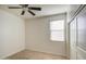 Bright bedroom with a ceiling fan, window with blinds, carpet, and a closet at 23649 W Watkins St, Buckeye, AZ 85326