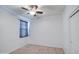 Bedroom with a ceiling fan, window with curtains, closet, and carpet at 23649 W Watkins St, Buckeye, AZ 85326