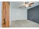 Bedroom featuring ceiling fan, grey accent wall, and a barn door at 23649 W Watkins St, Buckeye, AZ 85326