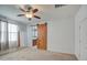 Bedroom with ceiling fan and a barn door leading to the bathroom at 23649 W Watkins St, Buckeye, AZ 85326