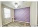 Unique bedroom featuring wood look tile flooring and a purple accent wall at 23649 W Watkins St, Buckeye, AZ 85326