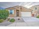 Inviting single-Gathering home displaying desert landscaping, two-car garage, and charming front entryway at 23649 W Watkins St, Buckeye, AZ 85326