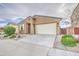 Attractive home featuring desert landscaping, two-car garage, and a well-kept front yard at 23649 W Watkins St, Buckeye, AZ 85326