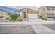Well-maintained single Gathering home showcasing desert landscaping, two-car garage, and inviting facade at 23649 W Watkins St, Buckeye, AZ 85326