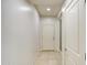 Bright entryway with neutral-colored tile flooring and a white front door at 23649 W Watkins St, Buckeye, AZ 85326