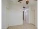 Bright hallway featuring tile floors, doors, and modern lighting fixtures at 23649 W Watkins St, Buckeye, AZ 85326
