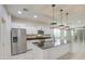 Modern kitchen featuring stainless steel appliances, an island, and stylish pendant lighting at 23649 W Watkins St, Buckeye, AZ 85326