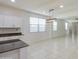 Kitchen and dining area showcasing tile flooring, island, and modern pendant lighting at 23649 W Watkins St, Buckeye, AZ 85326