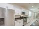 Well-lit kitchen featuring stainless steel appliances, decorative backsplash, and white cabinets at 23649 W Watkins St, Buckeye, AZ 85326
