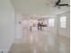 Bright open-concept space with tile flooring and a view into the kitchen at 23649 W Watkins St, Buckeye, AZ 85326
