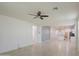 Open-concept living area featuring tile flooring, neutral walls, and a ceiling fan at 23649 W Watkins St, Buckeye, AZ 85326