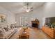 Cozy living room featuring a fireplace, neutral furniture, and hardwood floors at 2512 W Knowles Ave, Mesa, AZ 85202