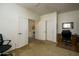 Bright bedroom featuring neutral walls, carpet floors, closet, and a workspace with a desk at 2663 S Springwood Blvd # 326, Mesa, AZ 85209