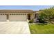 Charming single-story home featuring a three-car garage, manicured lawn, and inviting front porch at 2663 S Springwood Blvd # 326, Mesa, AZ 85209