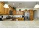 Bright kitchen featuring stainless appliances, granite countertops, and wood cabinets at 2663 S Springwood Blvd # 326, Mesa, AZ 85209