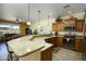 Well-lit kitchen featuring granite countertops, stainless steel appliances, and a breakfast bar overlooking living room at 2663 S Springwood Blvd # 326, Mesa, AZ 85209