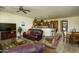 Open concept living room flowing into kitchen, featuring leather sofas, a ceiling fan, and natural light at 2663 S Springwood Blvd # 326, Mesa, AZ 85209