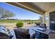 Covered patio featuring comfortable seating, a grill, and scenic views of the well-manicured green lawn at 2663 S Springwood Blvd # 326, Mesa, AZ 85209