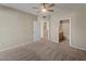 Bedroom with access to an ensuite bathroom and neutral carpet and paint at 2992 N Miller Rd # 103, Scottsdale, AZ 85251