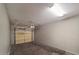 Attached, empty one-car garage with door and overhead lighting at 2992 N Miller Rd # 103, Scottsdale, AZ 85251