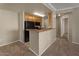 Practical kitchen featuring essential appliances and a cozy breakfast bar opening to the living area at 2992 N Miller Rd # 103, Scottsdale, AZ 85251
