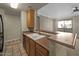 Convenient kitchen layout featuring a breakfast bar with sink and ample cabinet space, great for meal prep at 2992 N Miller Rd # 103, Scottsdale, AZ 85251