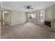 Bright and spacious living room with a fireplace, sliding glass doors, and seamless access to kitchen at 2992 N Miller Rd # 103, Scottsdale, AZ 85251