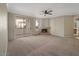 Open concept living room featuring neutral paint, ceiling fan and an inviting fireplace at 2992 N Miller Rd # 103, Scottsdale, AZ 85251