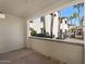 Relaxing covered patio overlooking courtyard landscape with palm trees at 2992 N Miller Rd # 103, Scottsdale, AZ 85251
