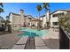 Community pool with lounge chairs and covered seating area at 2992 N Miller Rd # 103, Scottsdale, AZ 85251