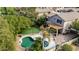 Backyard aerial view featuring a pool, spa, patio, and artificial turf for a low-maintenance outdoor oasis at 314 W Loma Vista St, Gilbert, AZ 85233