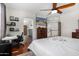 Well-lit bedroom with a desk and chair, TV, hardwood floors and view to the hallway at 314 W Loma Vista St, Gilbert, AZ 85233