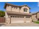 Home featuring a three car garage, desert landscaping, and a tile roof at 314 W Loma Vista St, Gilbert, AZ 85233