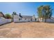 Vast backyard featuring a bright white exterior, chimney, and mature trees on a sunny day at 3624 W Whitten St, Chandler, AZ 85226