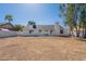 Large backyard featuring a bright white exterior, chimney, and mature trees at 3624 W Whitten St, Chandler, AZ 85226