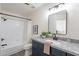 Modern bathroom with a sleek vanity, a framed mirror and a shower-tub combination at 3624 W Whitten St, Chandler, AZ 85226