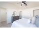 An airy bedroom with a ceiling fan, white walls, and a large dresser at 3624 W Whitten St, Chandler, AZ 85226
