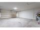 Spacious two-car garage with concrete flooring and a roll-up door ready for storage at 3624 W Whitten St, Chandler, AZ 85226