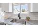 Kitchen sink area with stainless steel sink, gray countertop, white subway tile backsplash, and white cabinets at 3624 W Whitten St, Chandler, AZ 85226