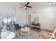 Inviting living area with modern fan, wood flooring, and open access to the kitchen at 3624 W Whitten St, Chandler, AZ 85226