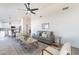 Open-concept living room with a comfortable sofa, chairs, a ceiling fan, and lots of natural light at 3624 W Whitten St, Chandler, AZ 85226