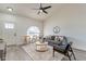 Bright living room with vaulted ceilings, modern fan, and view to front entrance at 3624 W Whitten St, Chandler, AZ 85226