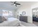 Bedroom with a ceiling fan, dresser, and a large window with lots of natural light at 3624 W Whitten St, Chandler, AZ 85226