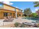 Beautiful backyard with a covered patio, outdoor seating, pool, and lush landscaping at 3713 E Cat Balue Dr, Phoenix, AZ 85050