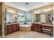 Luxurious bathroom featuring dual vanities, a soaking tub, and ample counter space at 3713 E Cat Balue Dr, Phoenix, AZ 85050